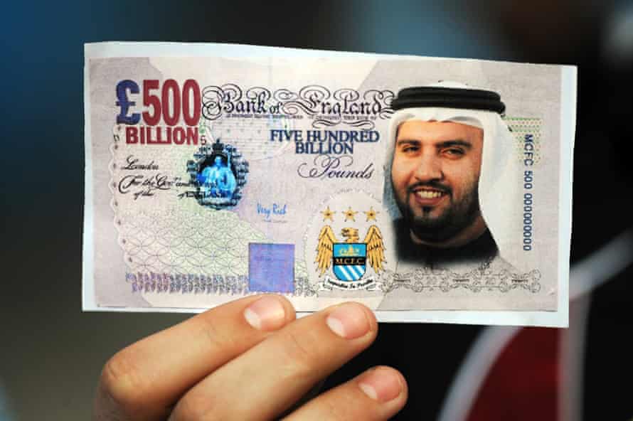 A Manchester City fan holds a fake banknote featuring the face of Sheikh Mansour back in 2008