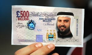 A Manchester City fan holds a mocked-up banknote with Sheikh Mansour’s face on it after the club’s 2008 takeover.