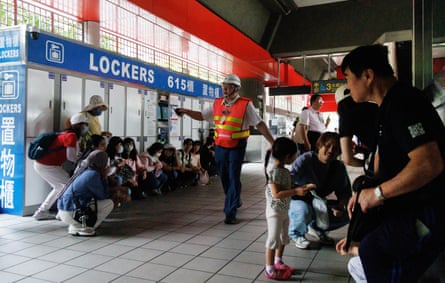 People take shelter during a simulation attack in Taipei