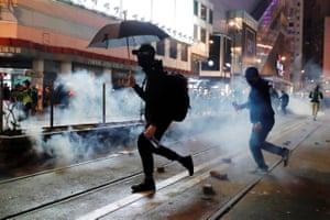 Protesters try to dodge teargas.