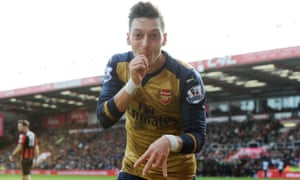 Mesut Ozil celebrates scoring the first Arsenal goal.