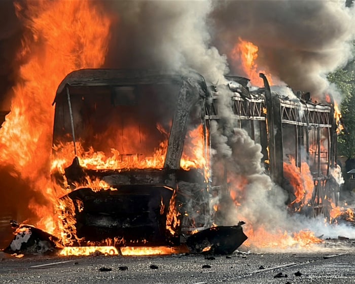 Bus set on fire as disorder flares up in Belfast – video