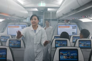 Crew members of Taiwan’s China Airlines dressed in jumpsuits receive training at their centre in Taoyuan, walking through a smoke-filled plane