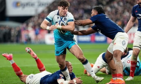 Tom Jordan is tackled by Peato Mauvaka during the Six Nations match between Scotland and France.