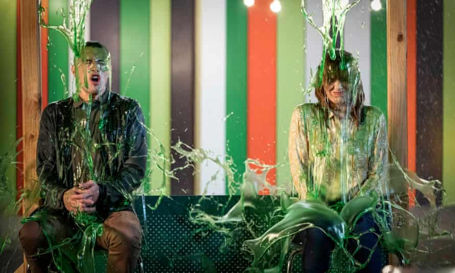 Hayden (Kevin Hofbauer) and Lauren (Katherine Parkinson) with green liquid pouring on to them.