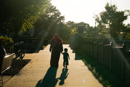 a woman and a child walk outside