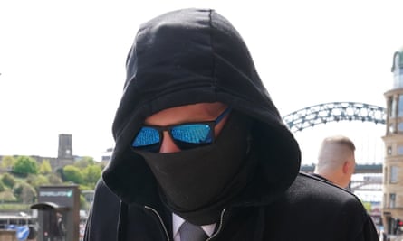 Adam Carruthers wearing sunglasses and a mask to cover most of his face
