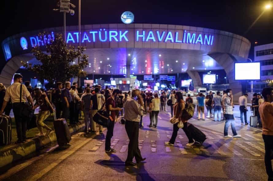 People stand outside the entrance after the attack at Istanbul Ataturk.