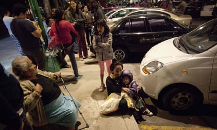 People wait on a street in Mexico City after the earthquake