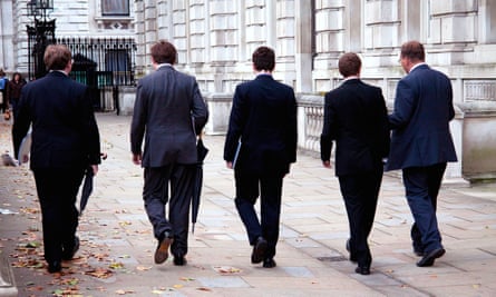 Five male junior civil servants walking down a path between buildings in Whitehall in September 2012