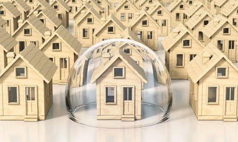 Toy wooden miniature houses, one under glass dome