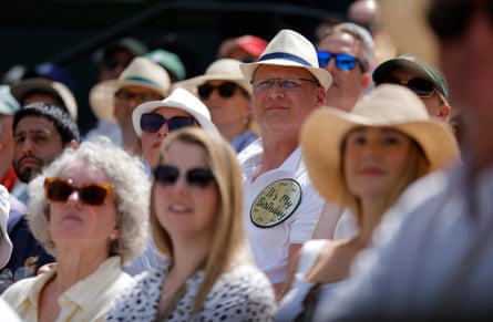 A spectator with a birthday badge on Centre Court.