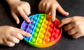 Children playing with a multicoloured fidget toy
