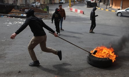 People stage a protest in Hebron after six Palestinians were killed by Israeli fire during a military raid on Tuesday in the West Bank city of Jenin.