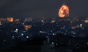 An explosion lights the sky following an Israeli air strike on Beit Lahia in the northern Gaza Strip on Friday.