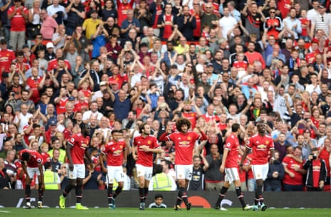 Marouane Fellaini of Manchester United celebrates scoring his sides second goal with his Manchester United team-mates.