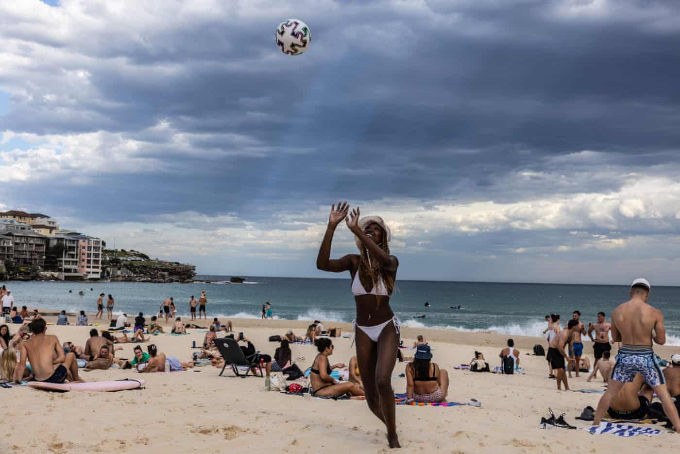 A woman plays with friends at Bondi beach on Saturday as temperatures soared to 33C