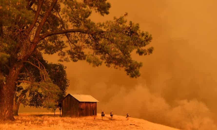 Firefighters watch as flames climb a hillside in Guinda, California, on 1 July 2018.