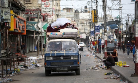 Palestinians transport their belongings on the back of a van as they flee Rafah in the southern Gaza Strip to a safer location on May 11, 2023, amid the ongoing conflict between Israel and the militant group Hamas.