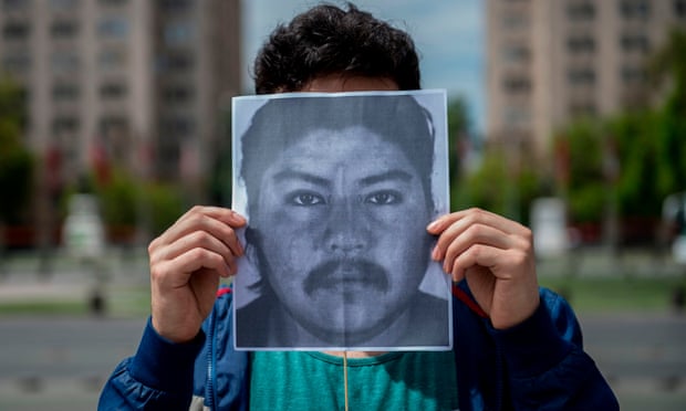 A demonstrator holds an image of Camilo Catrillanca in front of La Moneda Palace in Santiago, Chile, on 22 November. 