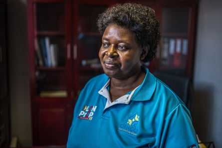 Sindy Matse stands in front of a bookcase with glass doors