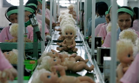 Labourers work on the production line at a toy factory in Panyu, south China’s Guangdong province.