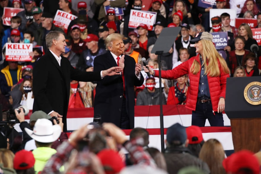Donald Trump attends a rally in support of the senators David Perdue Kelly Loeffler.