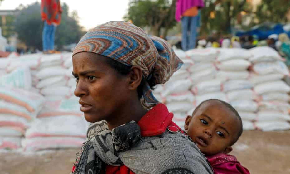 A mother and child queue for food in the Tigray region, Ethiopia.
