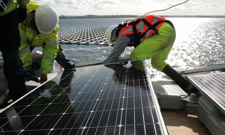 Solar panels being installed on the Queen Elizabeth II reservoir in London. Installations have plummeted since subsidy cuts took effect. 