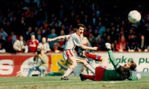 Ian Rush dinks the ball over Palace keeper Nigel Martyn to open the scoring.