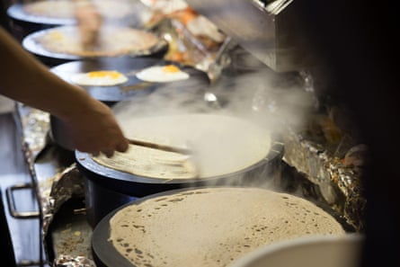 Cooking traditional galettes in France.