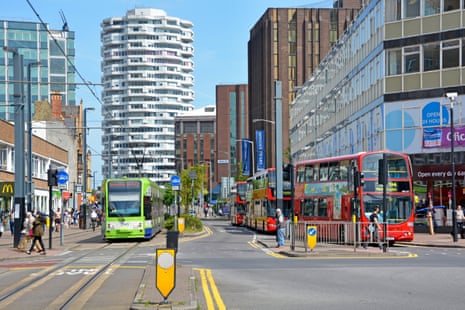 Croydon town centre with London double decker bus & tram public transport services & the No.1 Croydon NLA Tower landmark beyond