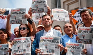People hold copies of today’s Cumhuriyet daily newspaper on July 28, 2017 during a demonstration in front of Istanbul’s courthouse