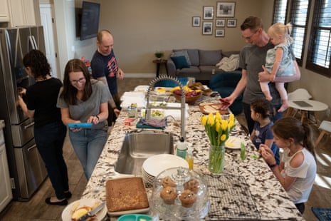 A family gathers around a large kitchen island