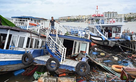 A man checks his damaged boat after Typhoon Yagi hit Ha Long Bay