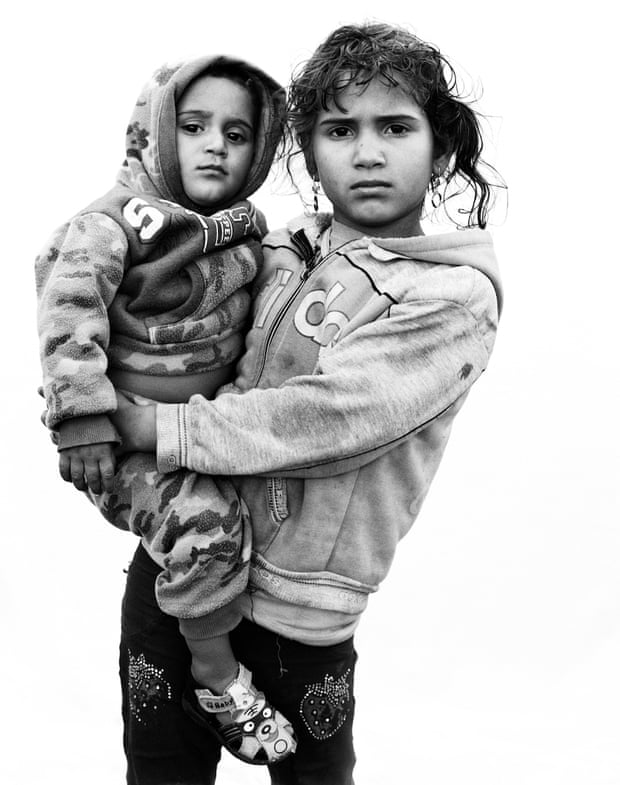 Lamis, five, from Homs, Syria, with her one-year-old brother Jad – a portrait taken in 2016 in Bekaa Valley, Lebanon.