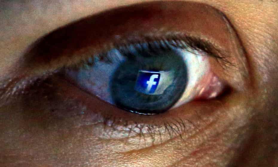 The Facebook logo seen reflected in a person's eye