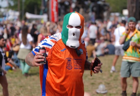 A festivalgoer wearing a tricolour balaclava