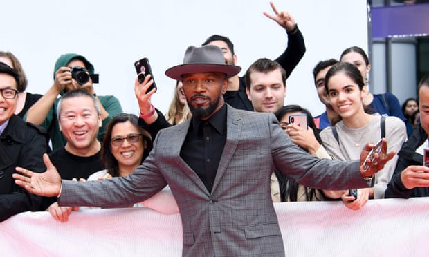 Actor Jamie Foxx poses with fans