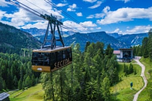a cable car surrounded by mountains