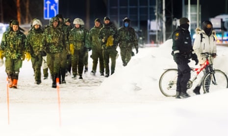 An asylum seeker arrives with a bicycle at the Vartius border station in Kuhmo, eastern Finland, on Sunday.