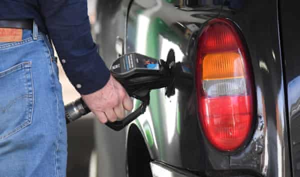 A man fills his car with fuel in London