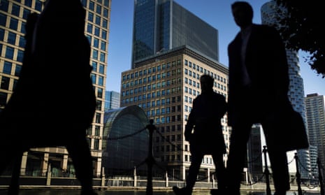 Office workers and commuters walking through Canary Wharf in London in the morning rush hour
