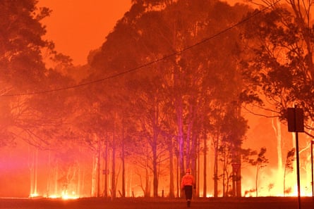 A firefighter battles the bushfires around the town of Nowra, New South Wales.