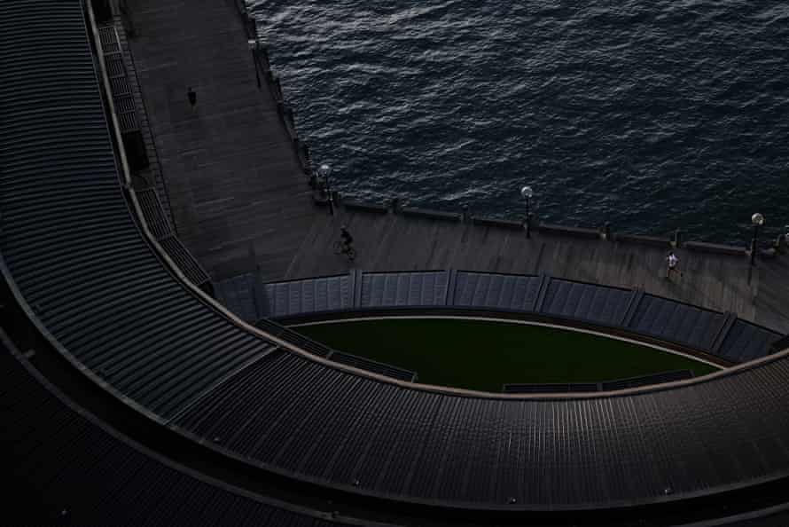 People exercise along the Sydney Harbour foreshore at sunrise in Sydney.
