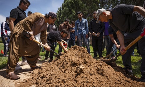 People spread earth over Aftab Hussein's grave at Fairview Memorial Park in Albuquerque, New Mexico, on Friday.