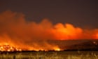 Firefighters work to contain 84 large blazes in western US and Canada