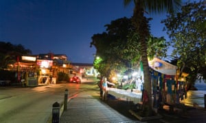 Tourists at souvenir stand at night St Lawrence Gap