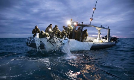 Members of the US navy with a Chinese high-altitude surveillance balloon off the coast of Myrtle Beach, South Carolina.