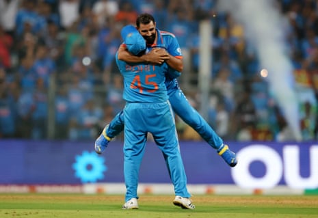 Mohammed Shami of India celebrates with teammate Rohit Sharma after dismissing Lockie Ferguson